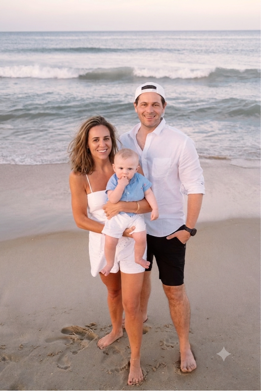 Morgan and Dave holding Charles together on the beach