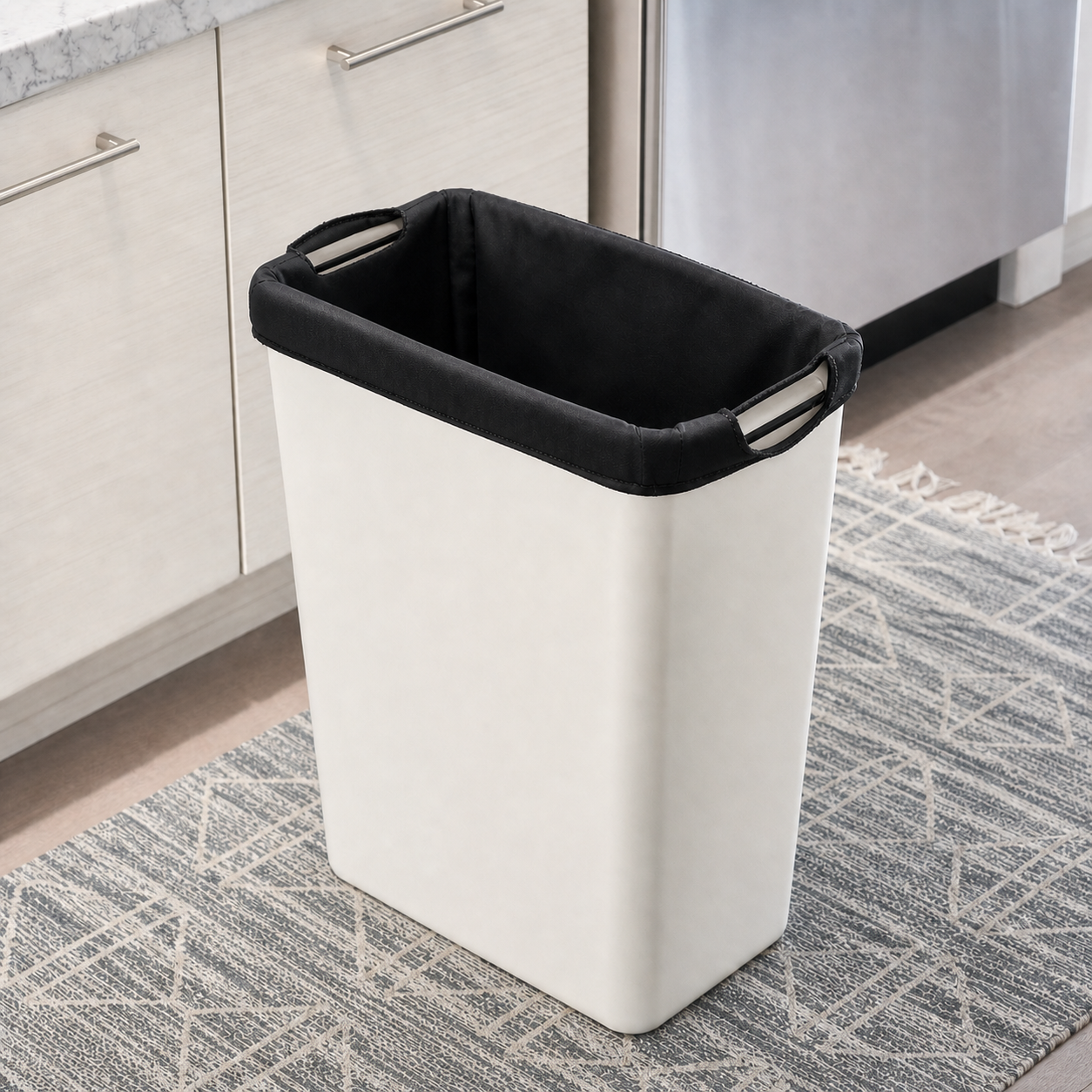Concept of a solid-black reusable liner fitted neatly inside a rectangular 13-gallon kitchen trash can